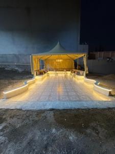 a large yellow tent with tables and chairs under it at دور سياحي in Abha