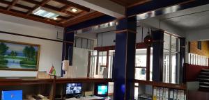 an office with blue columns and a desk with a computer at Rittoo Complex -Gavnor in Quatre Bornes