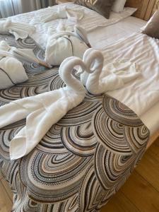 two towel swans are sitting on top of a bed at Apartament u Bartosów in Czarny Dunajec