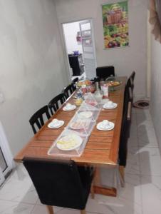 a long wooden table with food on it at Manancial de Aguas V in Barreirinhas