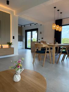 a kitchen and living room with a table and chairs at Kącik Na Dolinie in Groń
