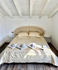 a bedroom with a bed with towels on it at Felicita Cascata Terrace with Lake View in Lecco