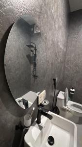 a bathroom with a sink and a mirror and a toilet at نزل سوم in Hail