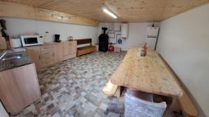 a kitchen with a table in the middle of a room at Carla House in Vidolm +62 photos
