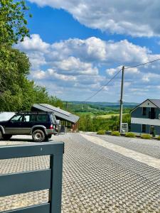a car parked on the side of a road at Domek Na Wzgórzu Roztocze in Majdan Abramowski