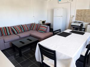 a living room with a couch and a table at El Rincón de km8 in Comodoro Rivadavia