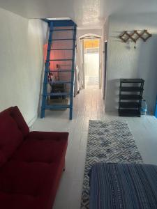 a living room with a red couch and a staircase at DaSH EV in Bodrum City