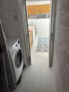 a kitchen with a washing machine in a hallway at DaSH EV in Bodrum City