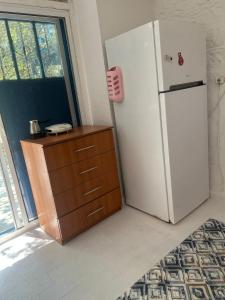 a kitchen with a refrigerator and a wooden dresser at DaSH EV in Bodrum City