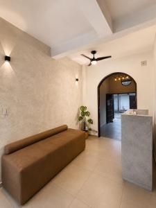 a large living room with a couch and a ceiling fan at Sarao in Santa Cruz de la Sierra