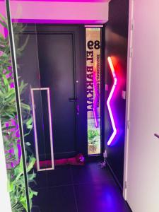 a room with a door with neon lights on it at Tommorowland Apartement in Boom
