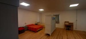 a room with a bedroom with a bed and a desk at Loft in Funes