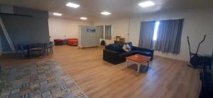 a living room with a couch and a flat screen tv at Loft in Funes