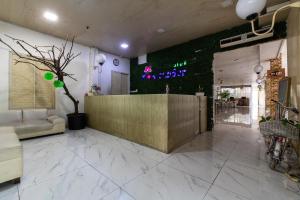 a lobby with a reception desk in a building at Hotel Aleander By ARBA in Jakarta