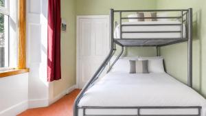 a bedroom with two bunk beds in a room at Ardyne House in Port Bannatyne