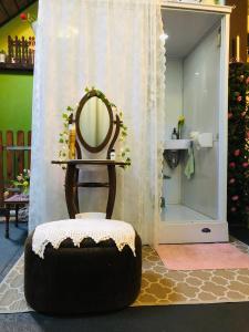 a chair with a mirror in a bathroom at Tijd-Loos in Geeste +90 photos