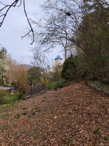 a dirt road with a water tower in the background at Golden Serafín - Romantic apartment below Karlštejn in Karlštejn