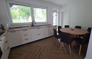 a kitchen with a table and a window and a table and chairs at MarioLia Comfort Residence in Oradea