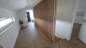 a hallway with a wooden partition in a house at MarioLia Comfort Residence in Oradea +8 photos