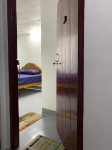 an open door to a room with a bed at Lathu - zen Stay Hotal in Trincomalee +23 photos