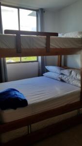 two bunk beds in a room with a window at Apartamentos en coveñas in Coveñas