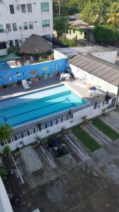 an overhead view of a swimming pool next to a building at Apartamentos en coveñas in Coveñas +10 photos