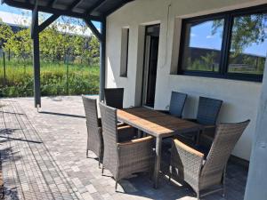 a wooden table and chairs on a patio at MarioLia Comfort Residence in Oradea