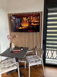a table and chairs in a room with a bar at Alvina 29 in Tsaghkadzor