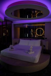 a bedroom with a large bed with purple lighting at Giafra Luxury Rooms in Agrigento