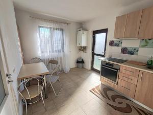 a kitchen with a table and a stove top oven at Virajlux Verde Retreat in Mioveni