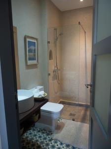 a bathroom with a shower and a toilet and a sink at Tigmi Anis Essaouira Diabat in Essaouira +35 photos