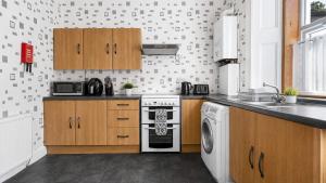a kitchen with a stove and a dishwasher at Ardyne House in Port Bannatyne