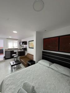 a bedroom with a large bed and a living room at Villa San Miguel in San Andrés