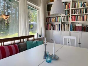 a living room with a white table and bookshelves at 7 person holiday home in Mönsterås in Mönsterås