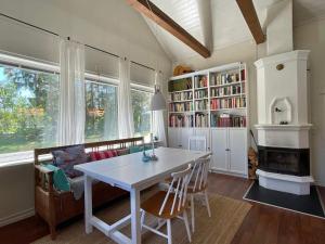 a dining room with a table and chairs and a fireplace at 7 person holiday home in Mönsterås in Mönsterås