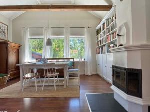 a living room with a table and a fireplace at 7 person holiday home in Mönsterås in Mönsterås +30 photos