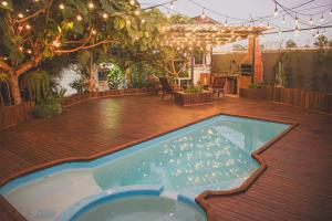 a patio with a swimming pool on a wooden deck at Cabana com Hidro, Lareira e Piscina Privativa in Chapecó