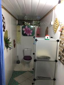 a small bathroom with a toilet in a room at Tureva lodge in Tiputa
