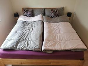 a bed with three pillows on top of it at Haus Sonnenschein in Bad Bertrich