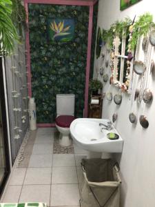 a bathroom with a toilet and a sink at Tureva lodge in Tiputa