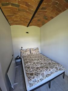 a bed in a room with a brick ceiling at Dom w Młodzianowie in Milicz +35 photos