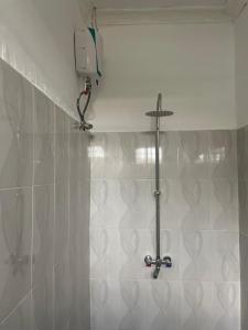 a bathroom with a shower with a cross on the wall at Zanzi coconut house in Jambiani +56 photos