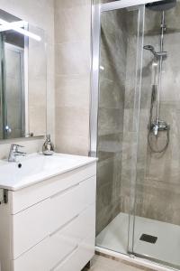 a bathroom with a sink and a shower at Apartamento Puerto Blanes in Blanes