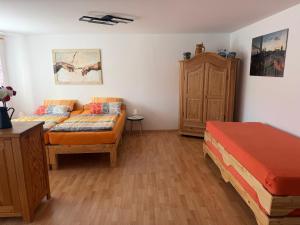 a bedroom with a bed and a couch in it at Ferienwohnung AARONA in Memmelsdorf