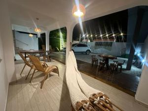a living room with a bed and a table and chairs at Pousada & Restaurante Almescla in Santa Cruz Cabrália