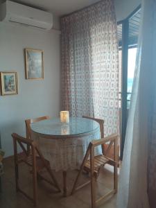 a dining room with a table and two chairs at Playa Velilla in Granada +5 photos