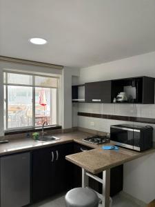 a kitchen with a counter and a sink and a window at Villa San Miguel in San Andrés +34 photos