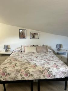 a bedroom with a large bed with a floral bedspread at Classense House in Classe