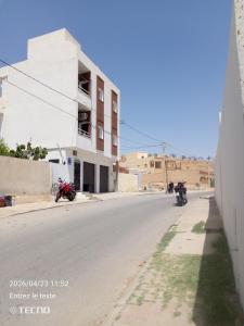 an empty street with motorcycles parked on the side of a building at Dar MORTADA TATAOUINE in Tataouine +34 photos