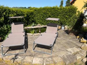 two chairs and a table on a patio at Ferienwohnung AARONA in Memmelsdorf